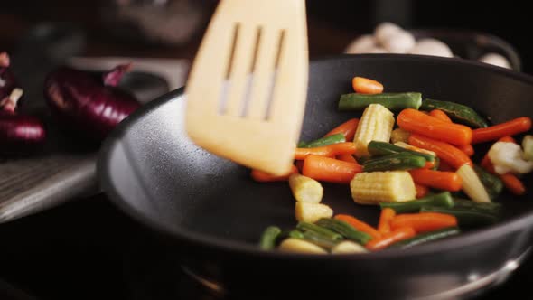 Chef Frying Vegetables in Pan Closeup