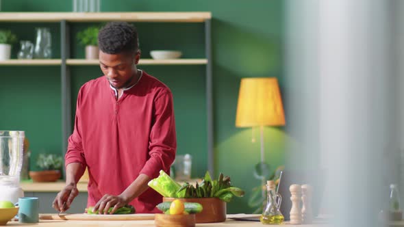 Afro-American Man Preparing Green Smoothie at Home