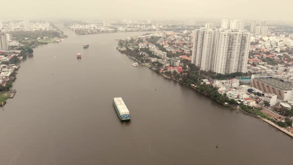 Aerial Drone Flight of Drones Cloudy Weather Overlooking the River with Container Ships Against 