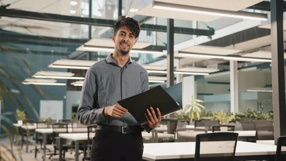 Young Arabian Confident Business Man Guy Stand in Modern Office Hold Folder Check Document Male