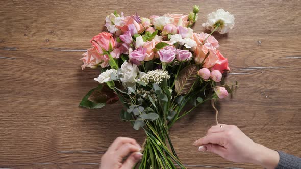 Florist Ties Bouquet with Thin Flexible Floral Rope on Table