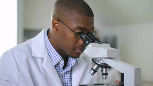 Man looking into microscope