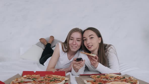 Girls Friends Eats Pizza and Watching TV at Home