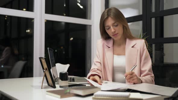 Attractive Business Woman Puts a Stamp on a Contract