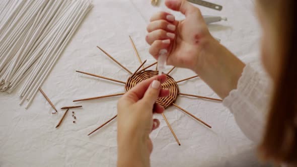 Mature Woman Making Paper Vine Basket at Home