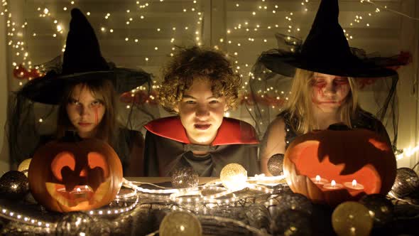 Halloween. Boy and Girls in Fancy Dress Play and Scare Each Other at Night at Home.