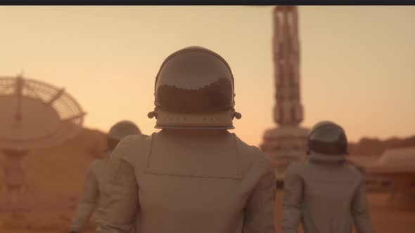 Three Astronauts in Space Suits Confidently Walking on Mars