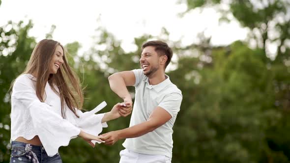 Romantic Happy Couple Having Fun And Dancing Outdoors In Nature.