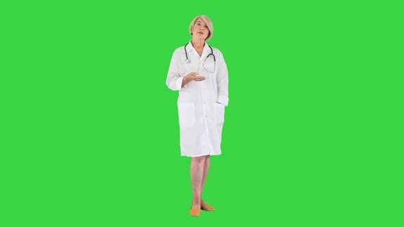 Pleasant Carrying Doctor Lady Talking To Camera on a Green Screen Chroma Key