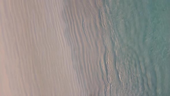 Waves Crashing on Tropical Beach at Sunset