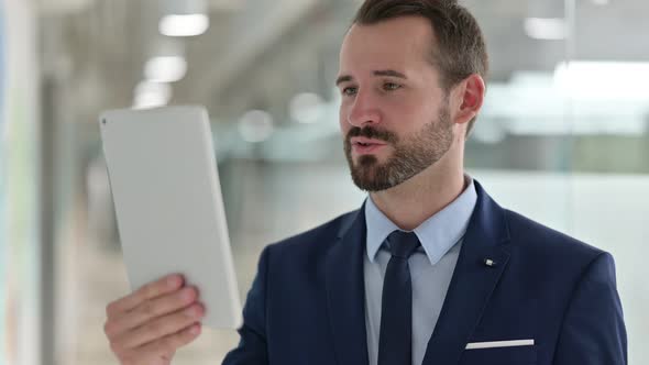 Portrait of Businessman Doing Video Call on Digital Tablet 