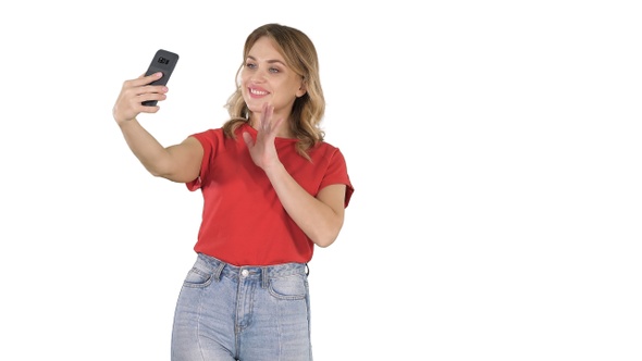 Cute girl making selfie walking on white background.