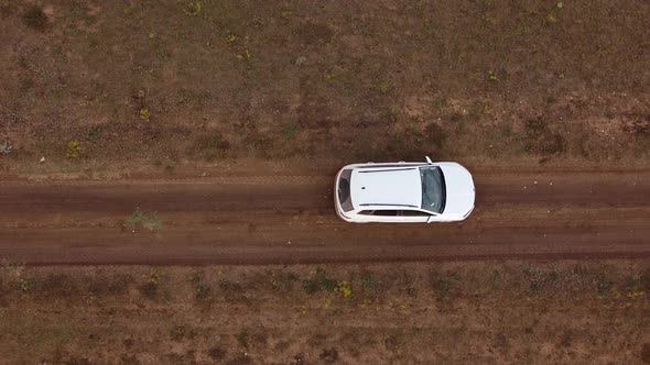 Camera Takes a Bird'seye View of a Moving Car in the Steppe