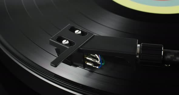 Closeup of Tonearm Headshell on Spinning Record