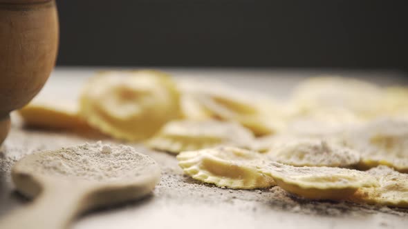 Cooking italian ravioli on wooden table.