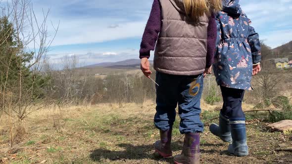 Two Lovely Kids Holding Hands Enjoying Landscape View