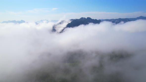 4K aerial view from a drone flying over the valley, fog in the morning