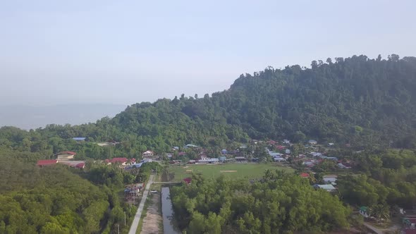 Aerial view Malays kampung at bottom of hill