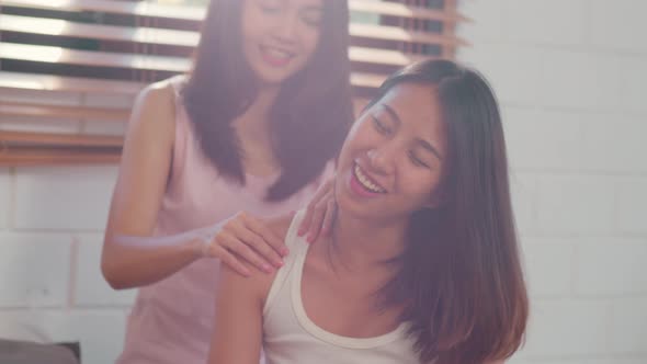 Asian Lesbian lgbtq women couple massage each other at home.