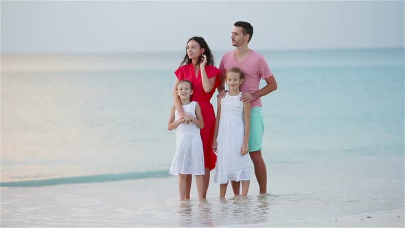 Happy Family with Kids Walk on the Beach