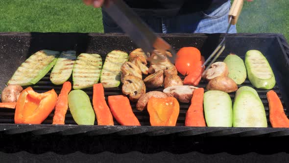 grilled vegetables on a wire rack with smoke and fire