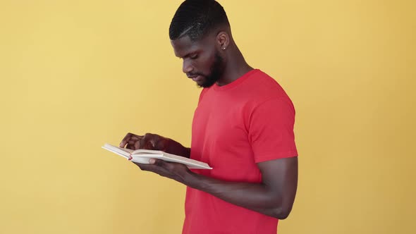 Tired African Student Reading Book Preparing Exam