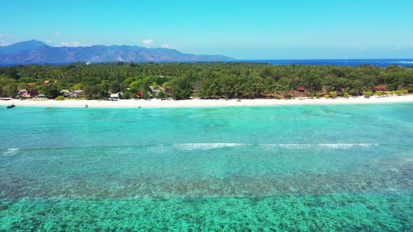 Aerial flying over landscape of perfect tourist beach lifestyle by transparent lagoon with white san