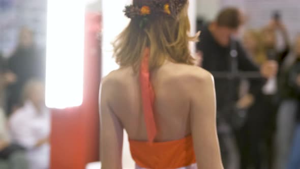 Woman in Summer Dress with Wreath Walks Down Runway