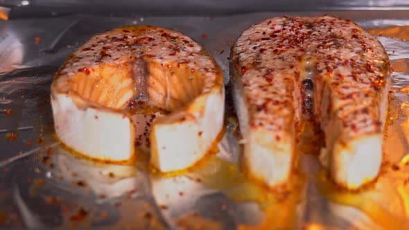 Baking salmon steak. Salmon steak with spices roasting in the oven slow motion. Salmon is baked