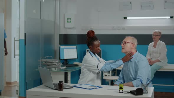 Woman Otologist Consulting Elder Patient for Medical Checkup