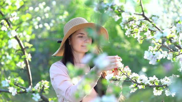 Beauty Young Woman Enjoying Apple Blooming Spring Orchard.