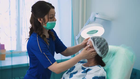 Cosmetologist Puts Cap Onto Client Head Before Procedure
