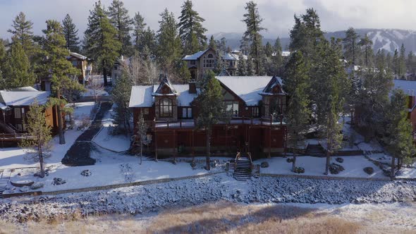 Nostalgic vintage old log house snow Christmas vibes Big Bear California aerial