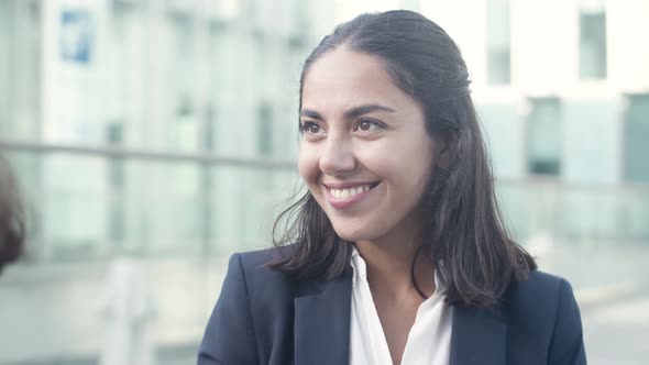 Friendly Cheerful Female Office Worker Chatting with Colleague