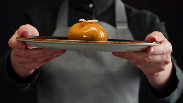 Woman Chef Holding Mousse Orange Cake Creamy Dessert Closeup