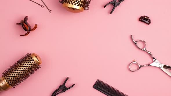 Stop motion animation of cutting shears and gold round hair brush for styling with pink