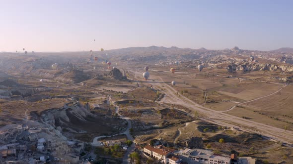 Cappadocia Landscape with Flying Hot Air Balloons.