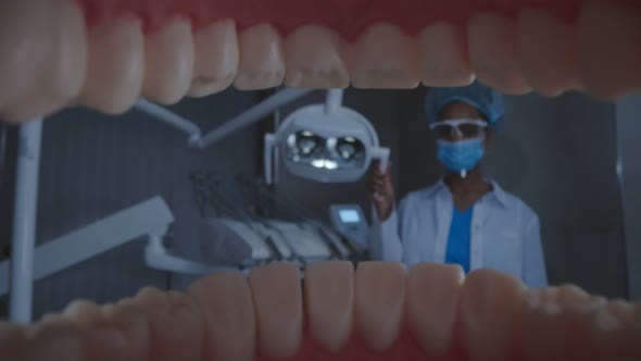 View From Inside Patient Opening Mouth and Dentist Turning on Lamp