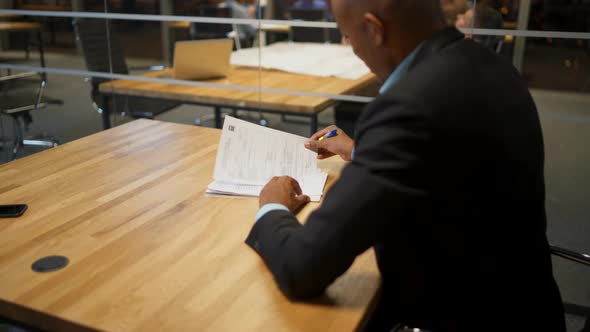 African Businessman and His Caucasian Colleague Signing Employment Docs in Office During the Meeting