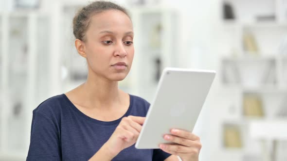 Portrait of Excited African Woman Having Success on Tablet