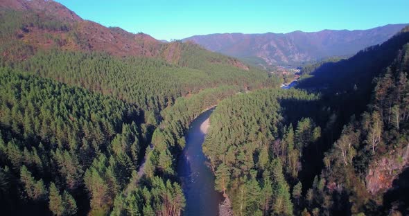 Low Altitude Flight Over Fresh Fast Mountain River with Rocks at Sunny Summer Morning