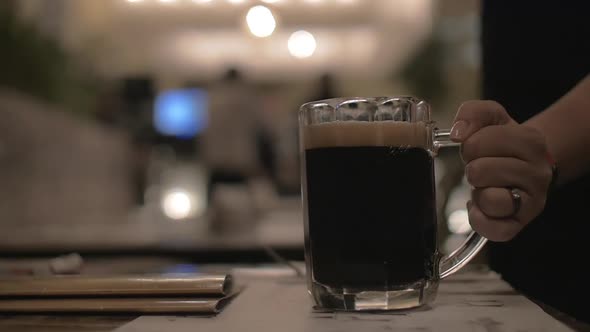 Serving mug of dark beer in cafe