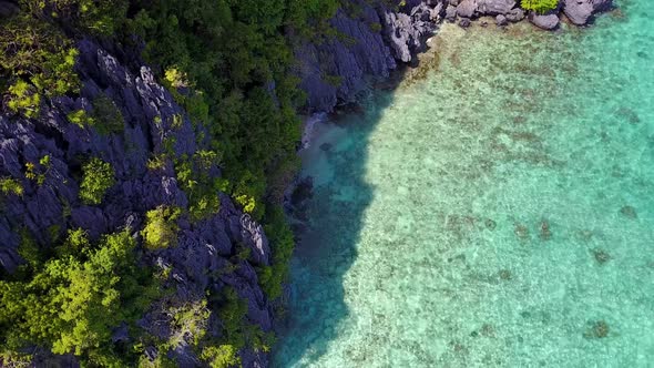 Aerial Fly-Over view of Karst Cliffs on Entalula Island, El-Nido. Palawan Island, Philippines