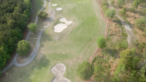 Aerial flight over Magnolia Greens Golf Course tilt reveal