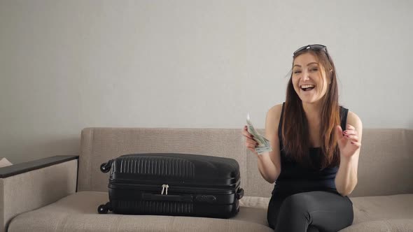 Girl with Money in Hand is Glad That Flies on Vacation