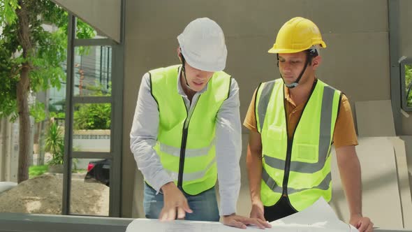 Asian construction builder and leader workers male people working onsite of architecture outdoors.