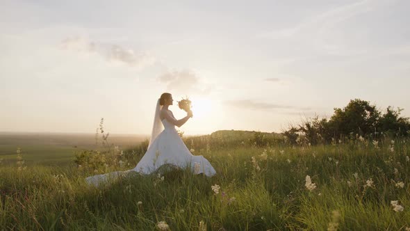 Attractive Young Bride Starts to Smell Her Bouquet