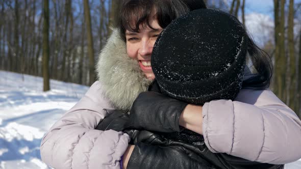 Happy Couple In Winter Park. Beautiful Girl Runs Toward Man Hugs Woman Slow Motion Snow Sunny Day 2