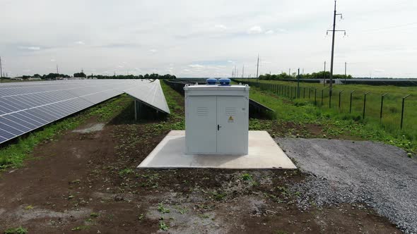 Aerial Footage of a Transformer in the Field Near the Solar Panels, 