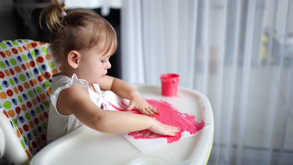 Cute Little Girl Painting with Fingers at Home